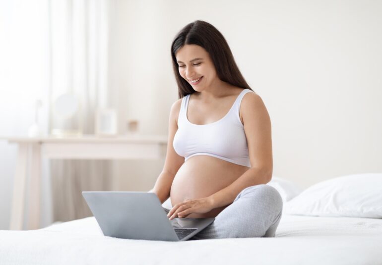 happy pregnant woman using computer at home 2023 11 27 05 01 04 utc 1